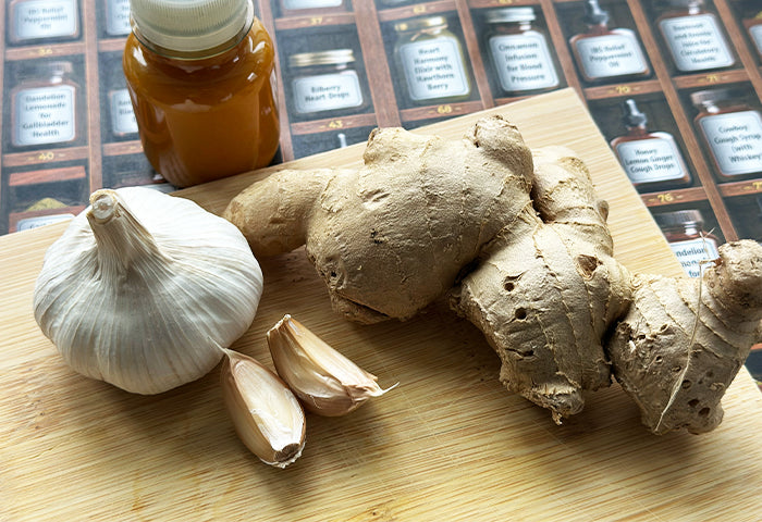 Garlic and ginger beside a traditional reference page